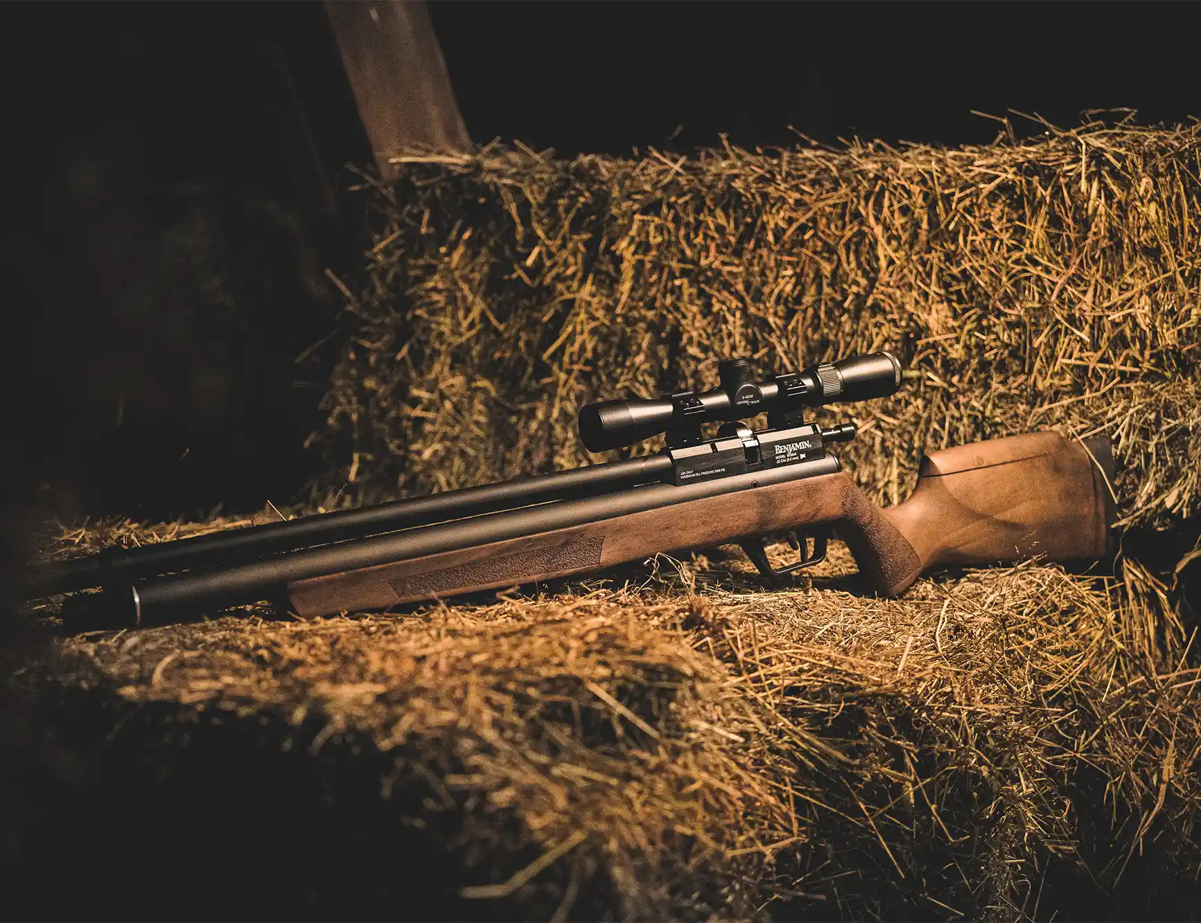 Benjamin Marauder Regulated BP64RW Indoor Lifestyle Sitting on a Pile of Hay