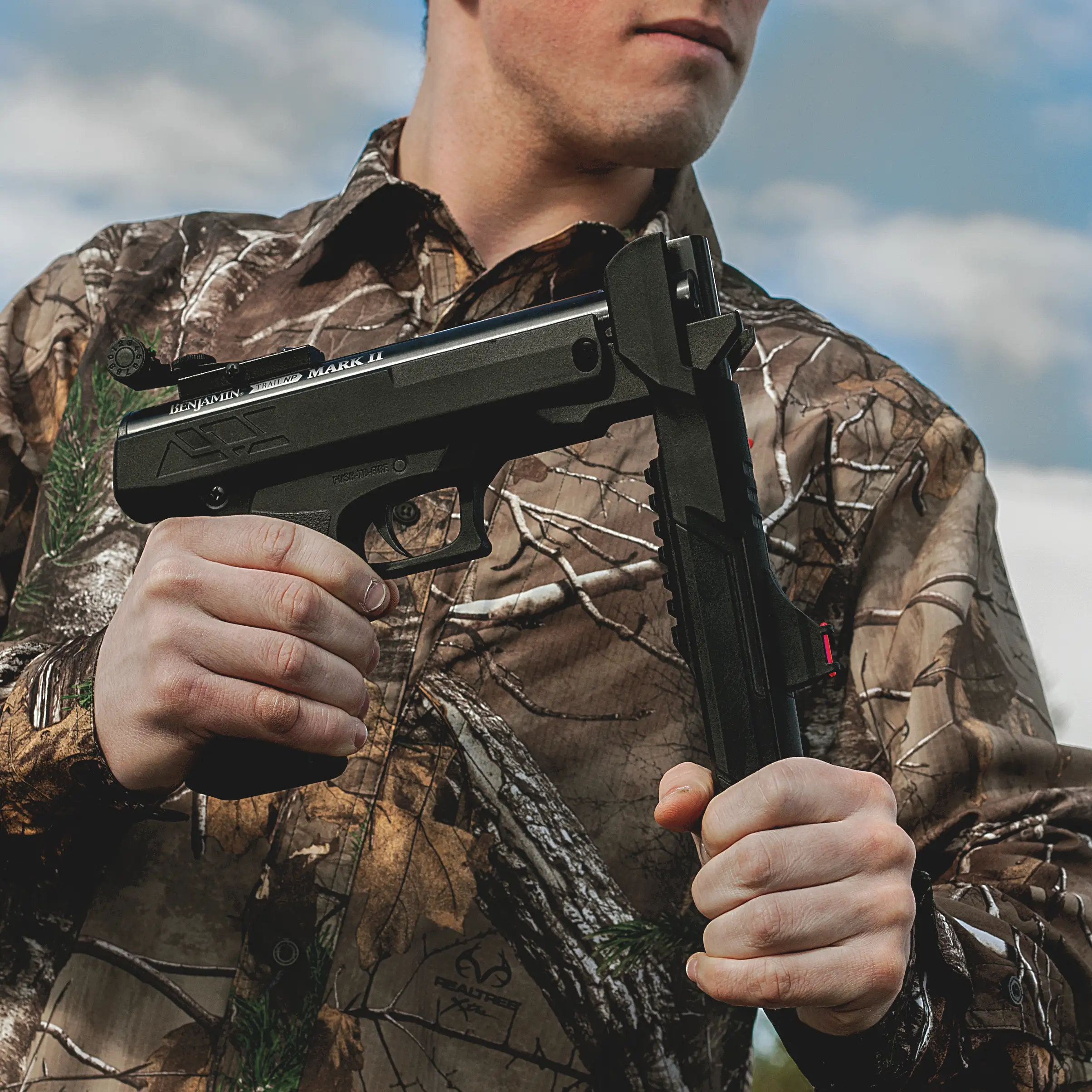 Benjamin Trail Pistol PBN17 Outdoor Lifestyle Being Cocked by Hunter